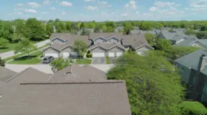 Aerial view of suburban homes with various roofing styles and potential roofing problems.