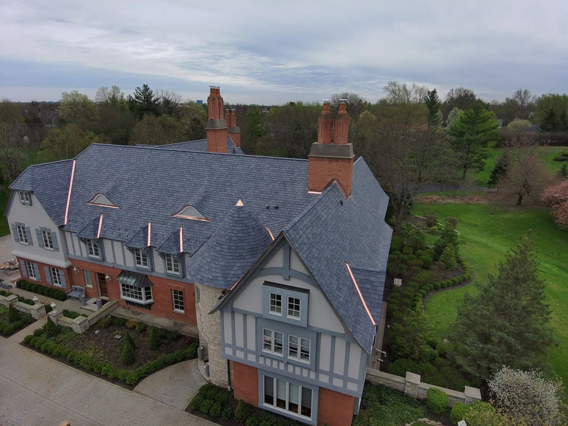 Elegant home with slate roofing showcasing sophisticated architectural design and durability.